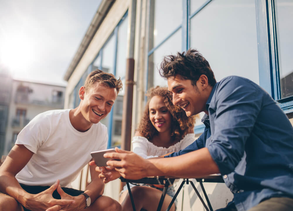 Friends looking up a local service on a phone